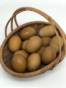 Basket of multiple olive egger eggs